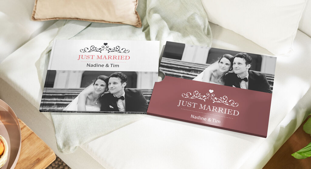 Two wedding albums titled 'Just Married' on a couch.