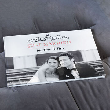 A beautiful photo book titled 'Just Married' features a couple on the cover. It radiates love and joy.