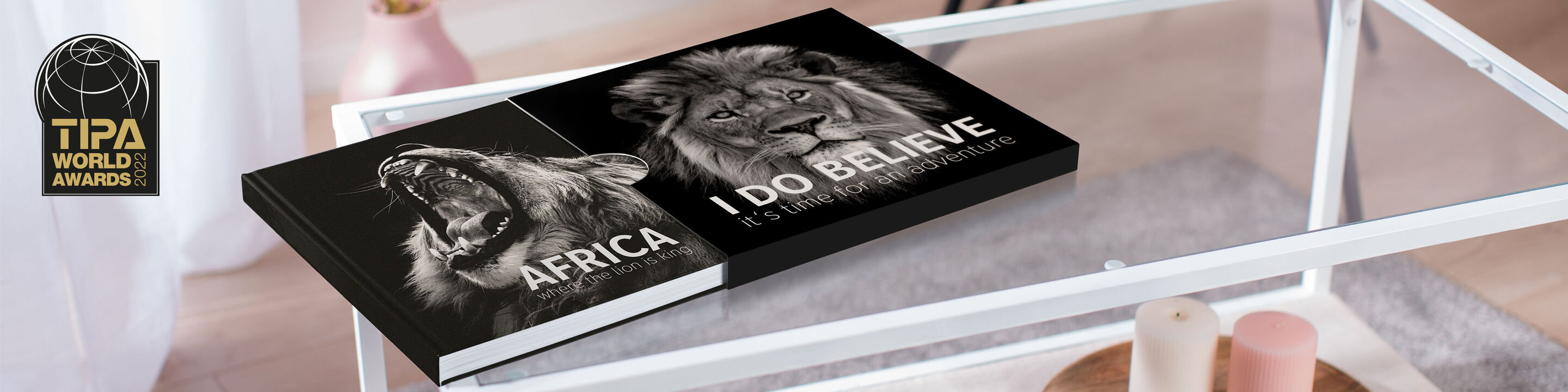 A high-quality photo book on a table, titled "Africa" with a majestic lion on the cover. Shows love for the African wilderness.