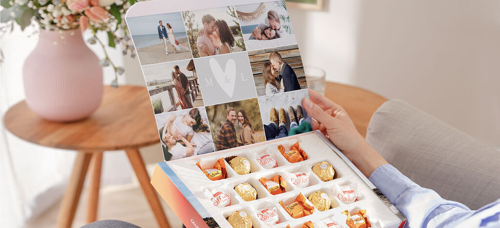 A person holds a CEWE greeting card box with chocolates. The inside shows happy moments.