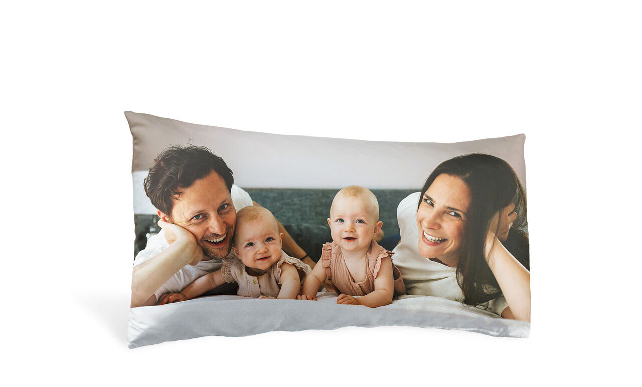 Sweet family photo on a cushion with two small children and parents.