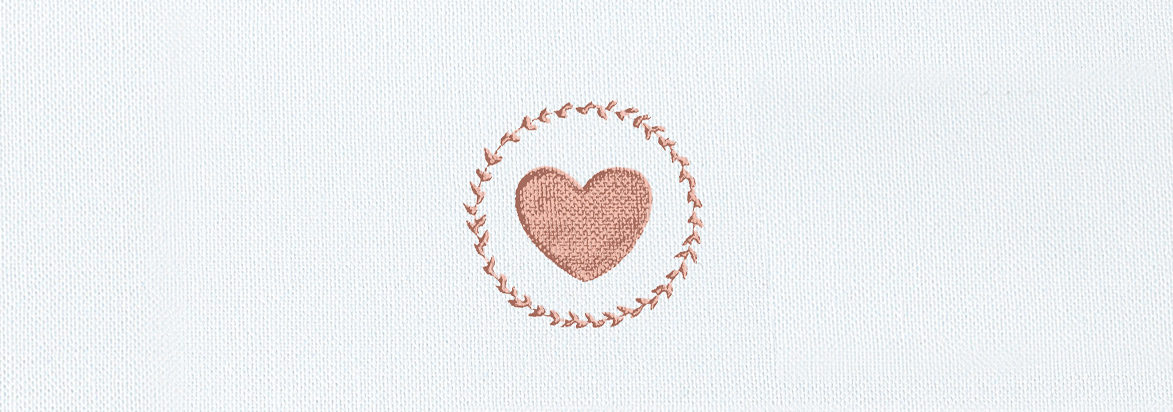 A lovingly embroidered heart in a delicate wreath.