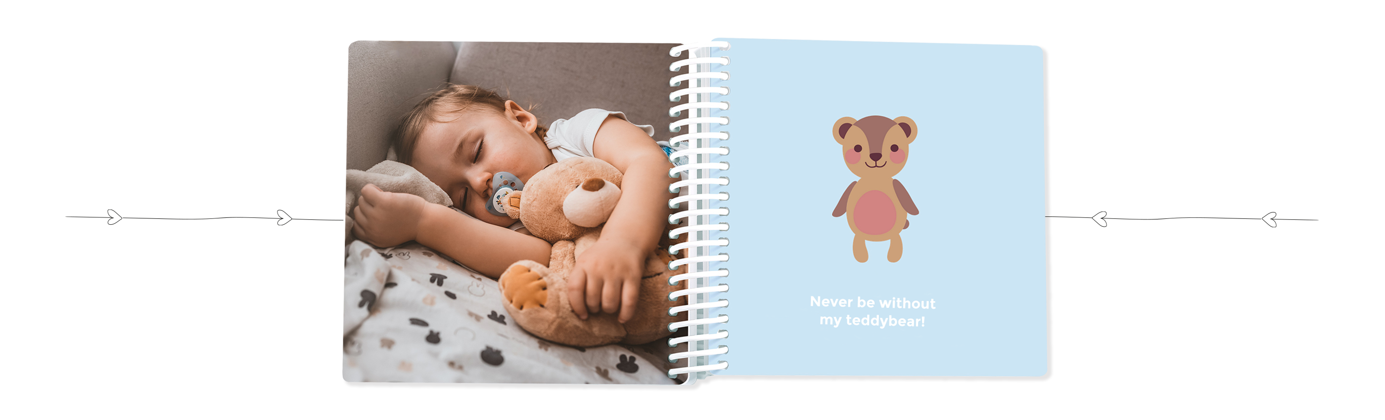 A child happily sleeps with a teddy and a CEWE photo book beside them.