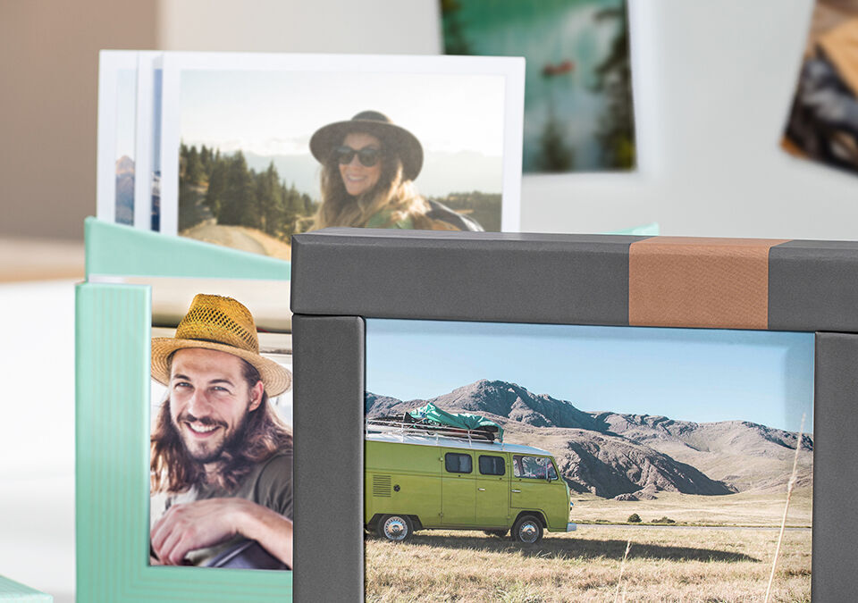 Two pictures in lovingly designed frames, one shows a vehicle in nature, the other a person among trees
