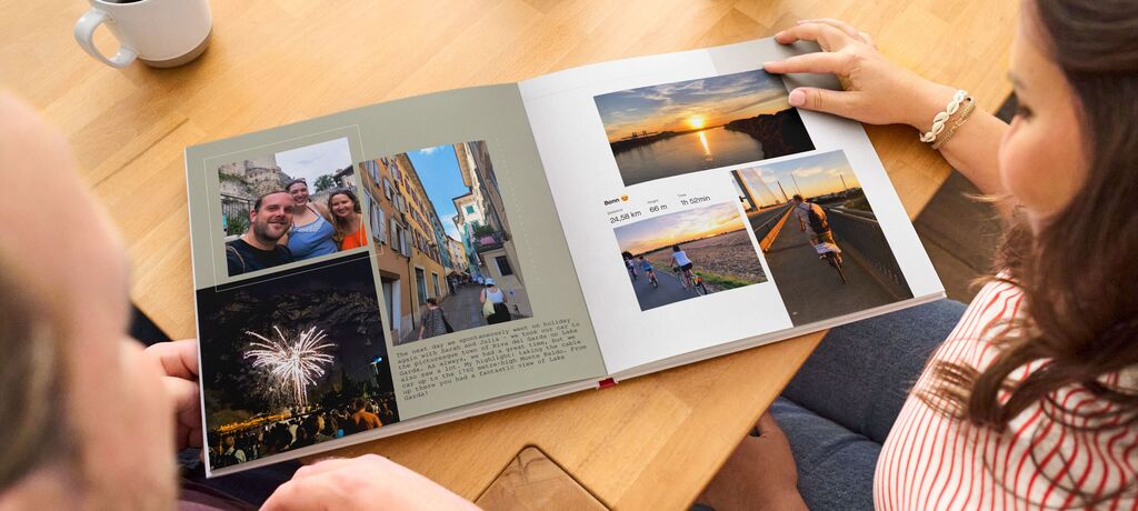 A person browses through a CEWE PHOTO BOOK with memories.