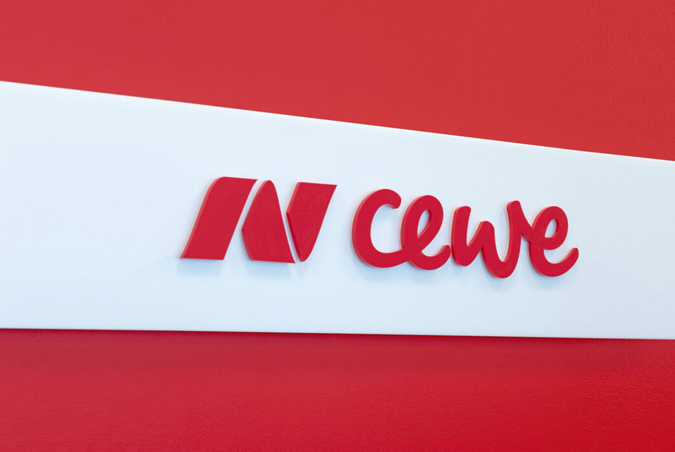 The CEWE logo on a red background.