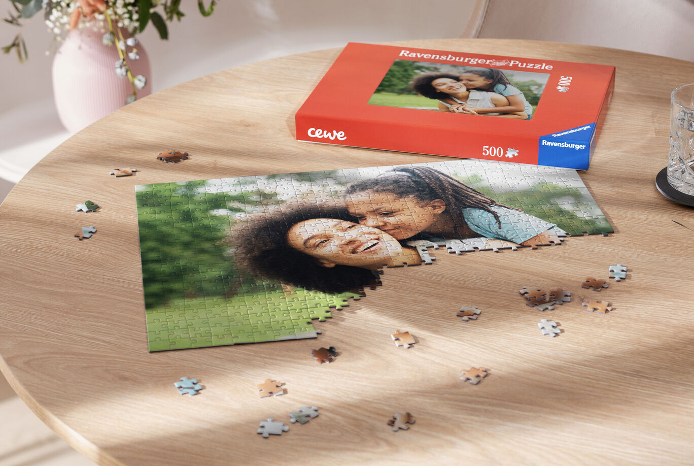 A lovingly designed puzzle with a smiling child and an adult on a table surface. Puzzle pieces and the box are visible.