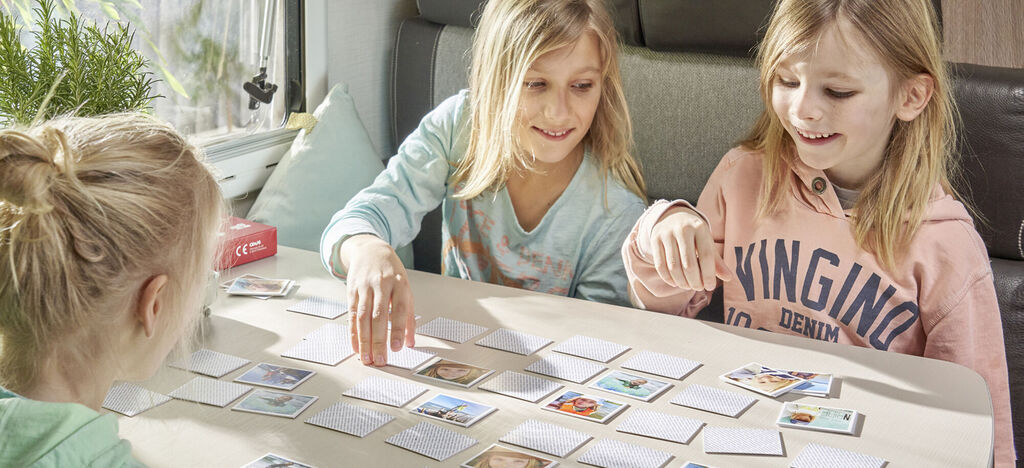 Children play with memory cards and laugh.