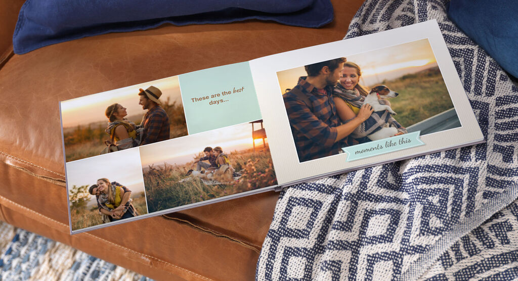 An open CEWE photo book shows emotional moments of couples and dogs in nature.