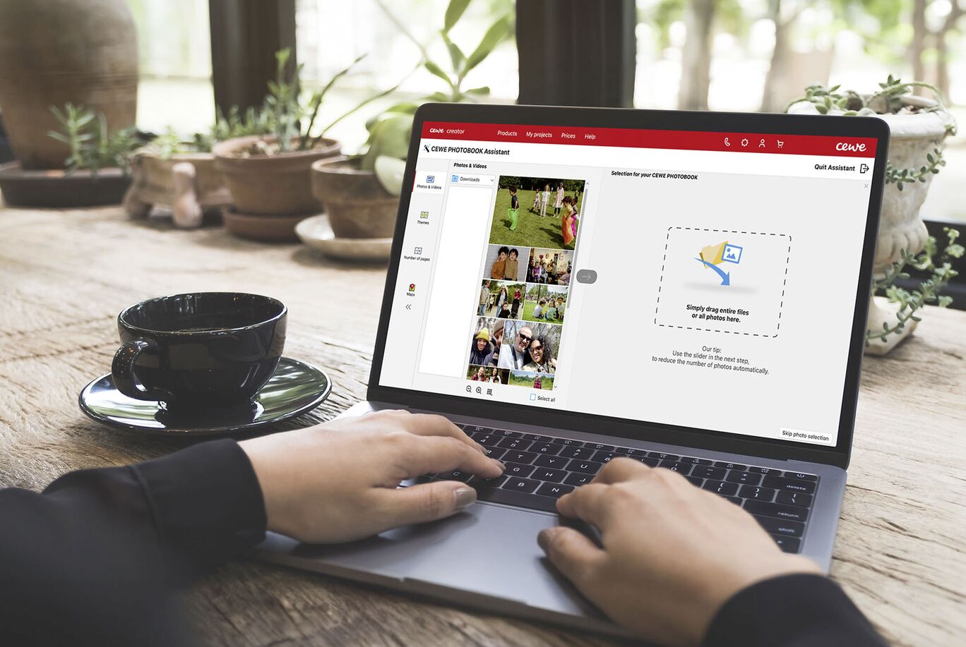 Person working on a laptop designing a CEWE photo book.