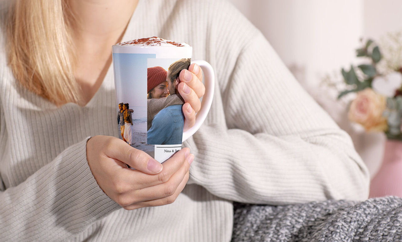 A person holds a personalized mug with photos of beautiful memories.
