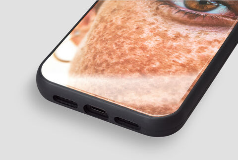 Detail view of a phone with a picture of a person taking a photo with it