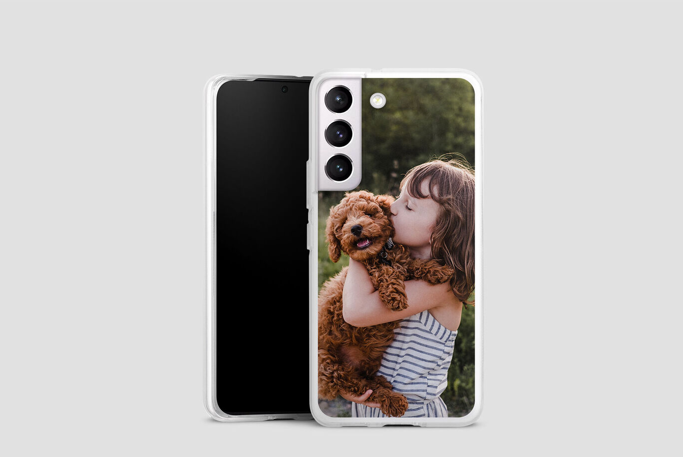 A child holding a dog in their arms.