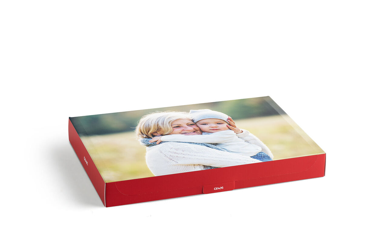 CEWE PHOTO BOOK with a loving family photo of mother and child in soft colors.