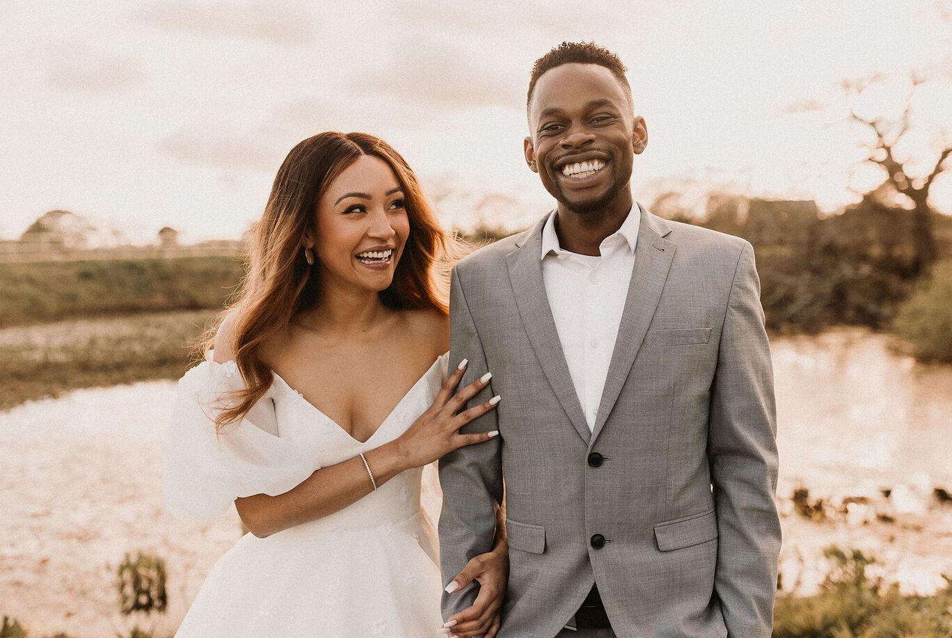 A happy couple holding hands at sunset.