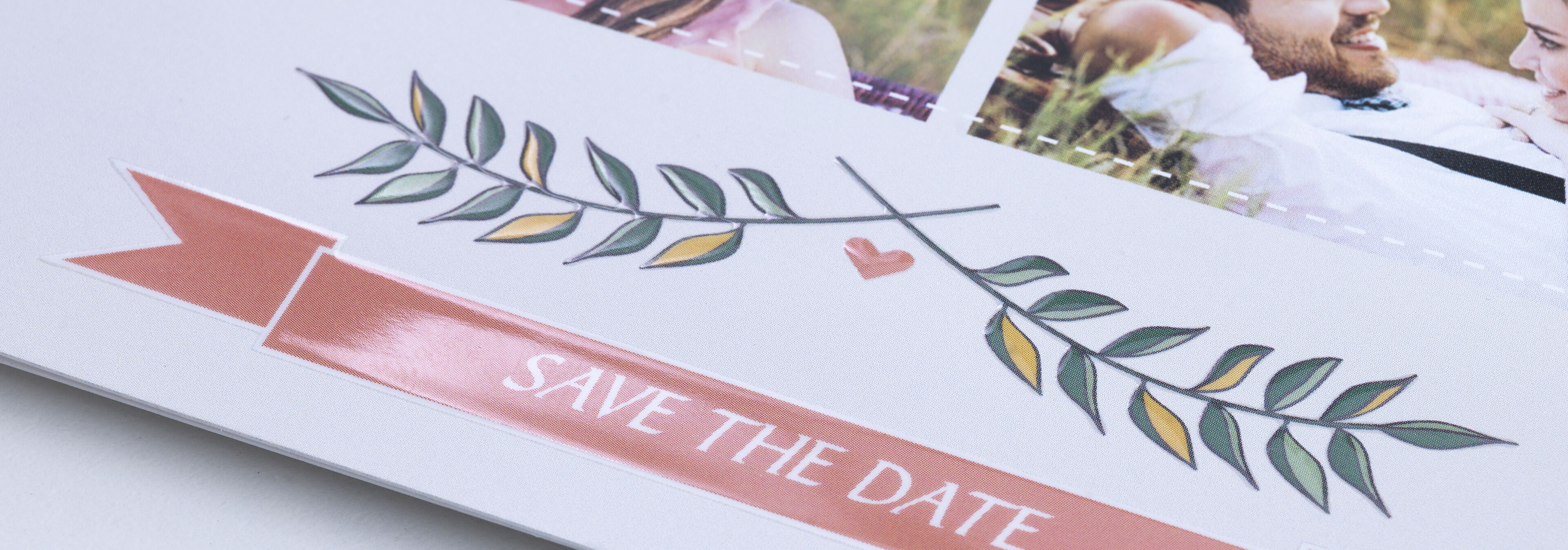 A happy moment: invitation card with the inscription 'SAVE THE DATE' and green leaves.