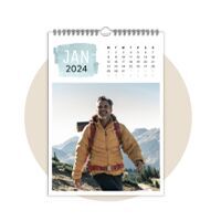 A happy man walks through the mountain landscape in a calendar for January 2024.