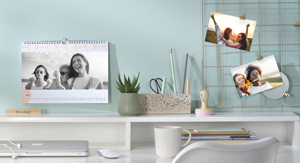 A beautifully set table with a calendar and photos of friends.