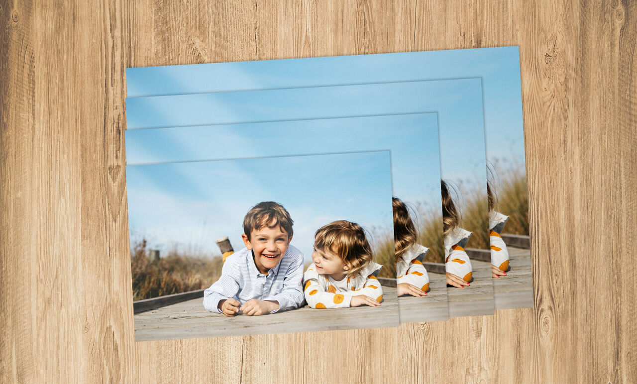 Two children relax on a wooden dock enjoying a sunny day.