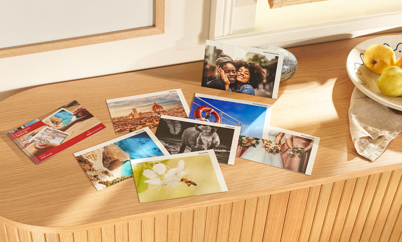 A selection of photos and postcards on a wooden shelf. Below, images of travels, flowers, and various memories are visible.
