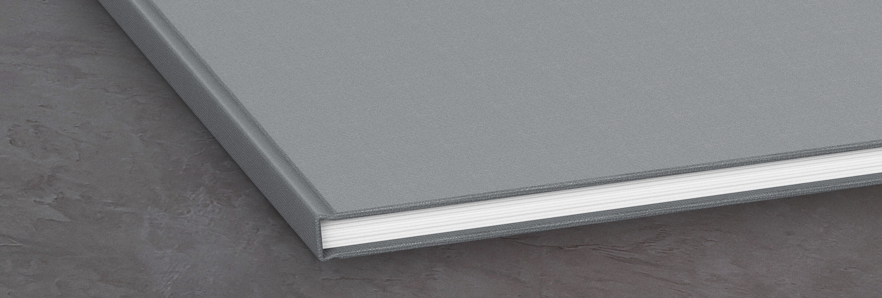 Close-up of a gray photo book with bound paper.