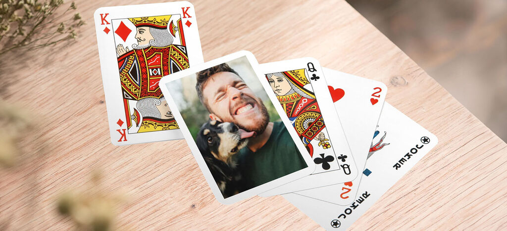A pair of playing cards on a table with a dog image