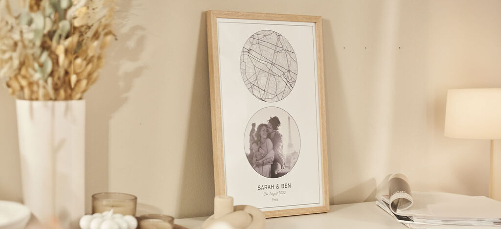 Two round picture frames on a table with three pale colors. A graphic pattern on top, a photo of a couple below.