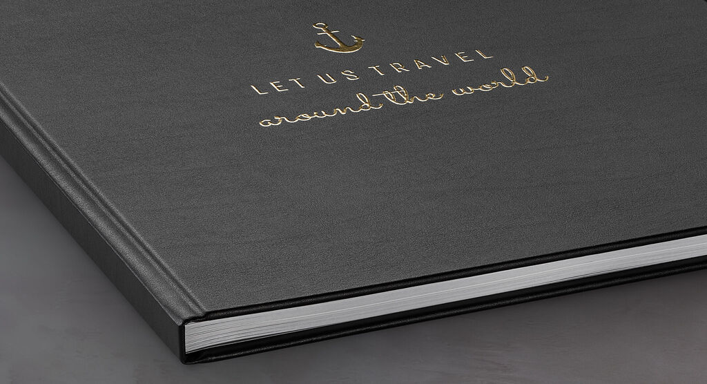 Black photo book with golden embossing "Let us travel around the world"