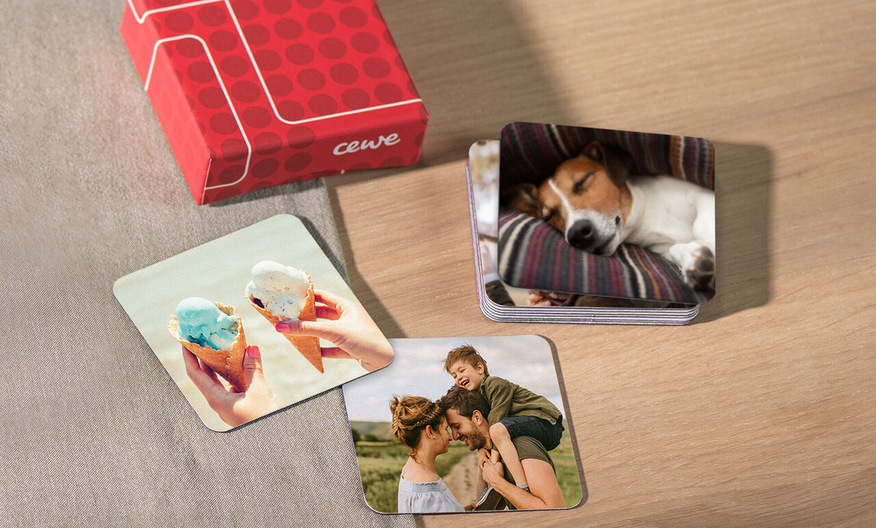 Two square photo cards show joyful moments: a child with an ice cream cone and a happy mother with her child. A red packaging box from CEWE.