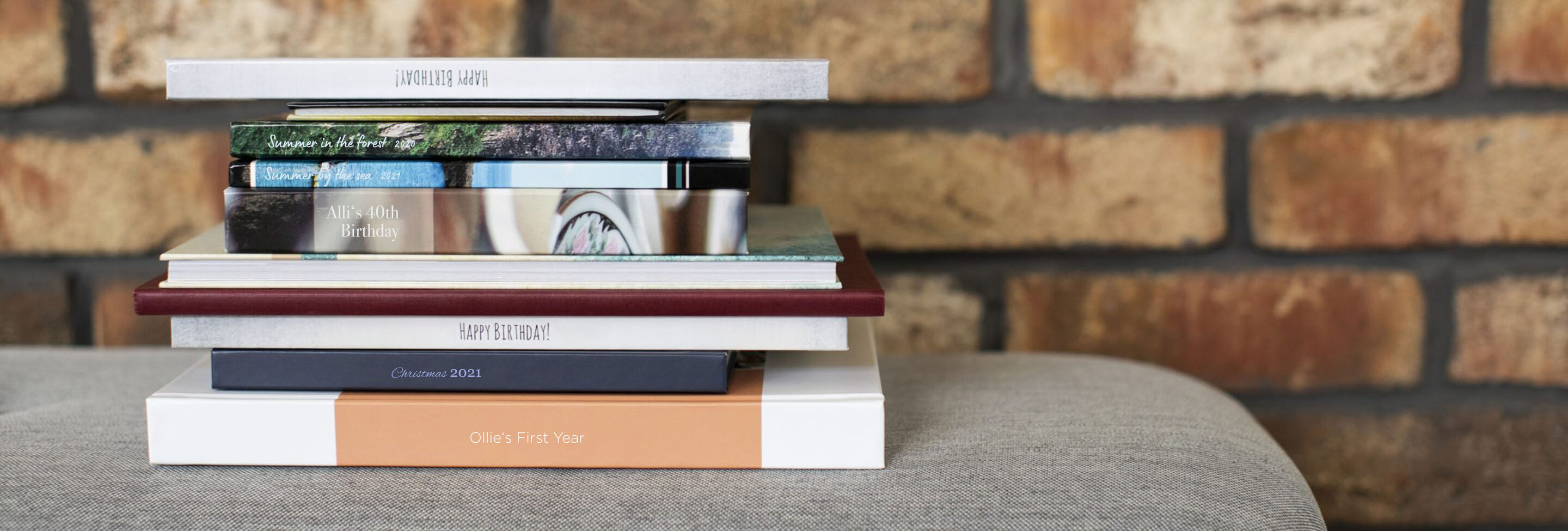 Stack of various CEWE photo books on a table