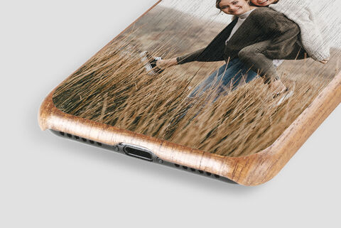 Phone case with a loving snapshot of a couple in a sunlit meadow