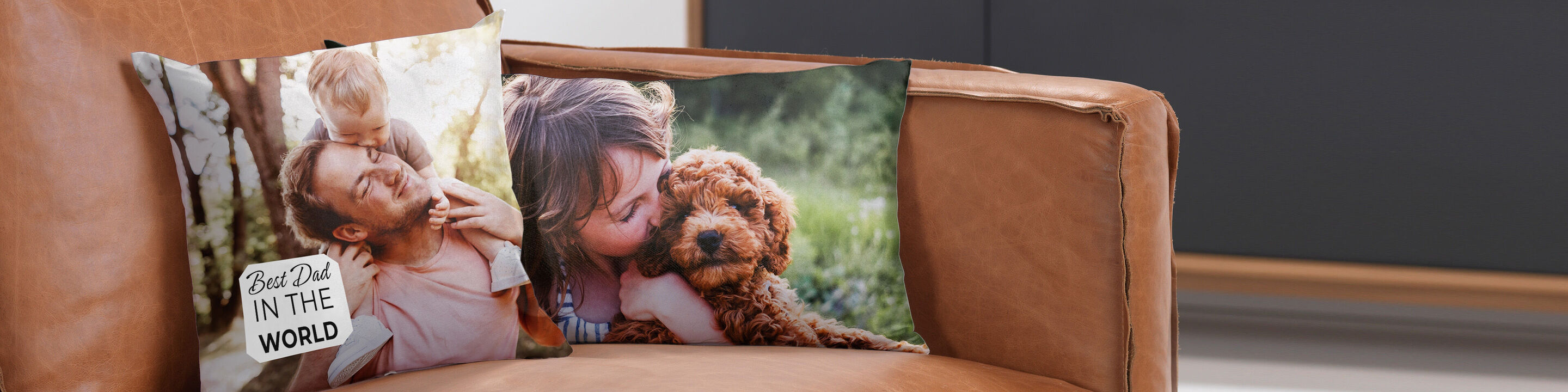 Two heart cushions on a sofa with photos. One shows a happy family, the other a loving hug with a dog.