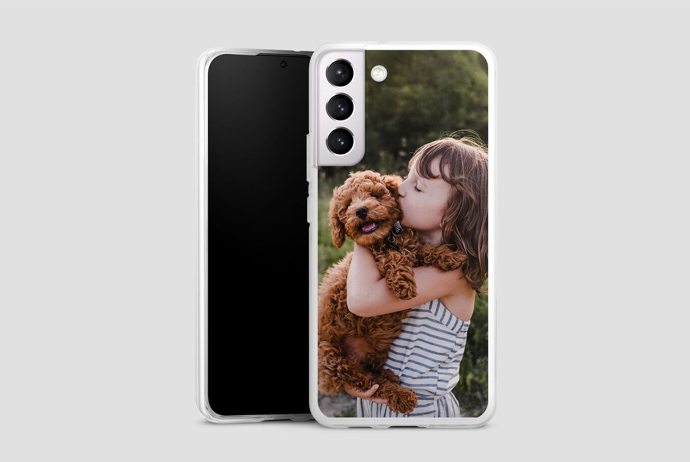 A child holding a happy dog in their arms, surrounded by nature