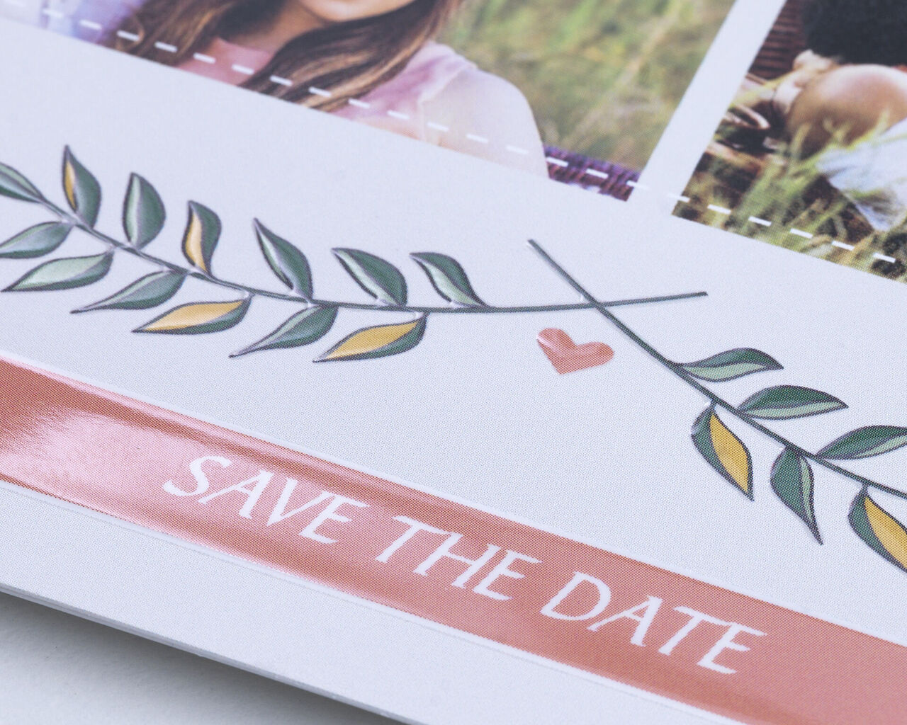 A cheerful 'Save the Date' with a heart and leaf decoration.