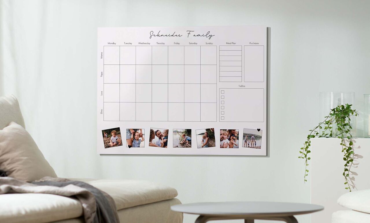 A calendar with memory photos and space for appointments on a wall.