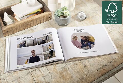 An open photo book lies on a table with beautiful memories and photos from Cardiff Beach.