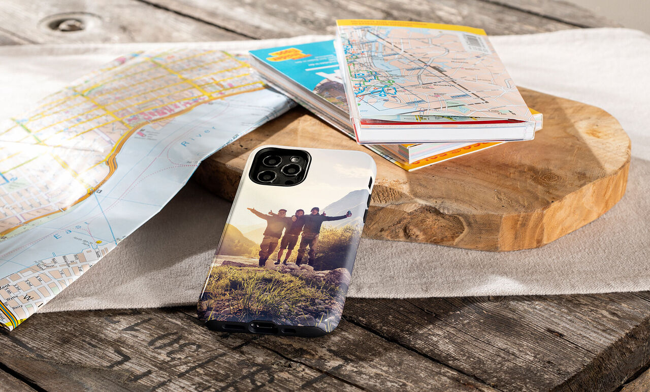 People happily stand on a meadow, with a photo case on a table.