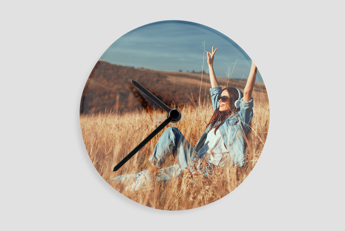 A creative wall clock with a cheerful design in a golden meadow.