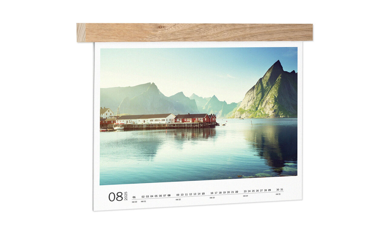 A beautiful view of mountains and a calm lake captured in a CEWE photo calendar.