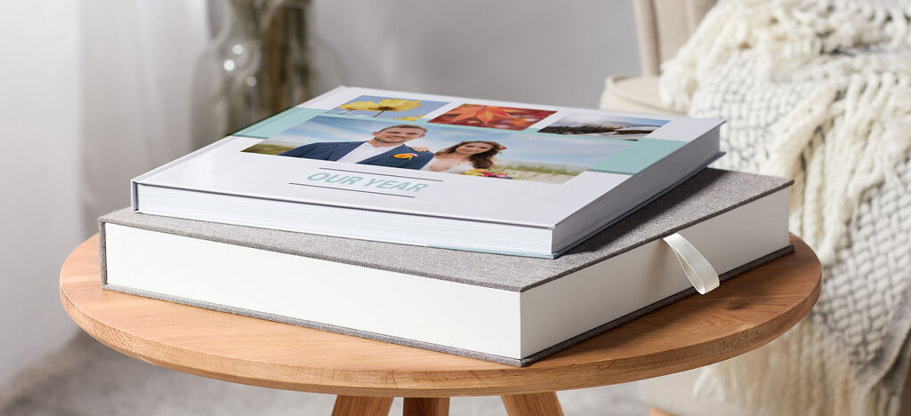 Two stylish photo books on a wooden table