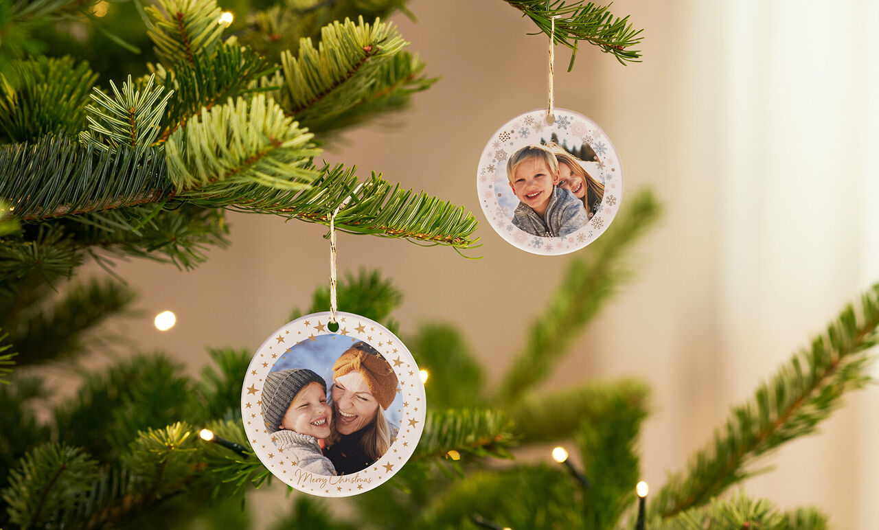 Two round photos adorn a Christmas tree.