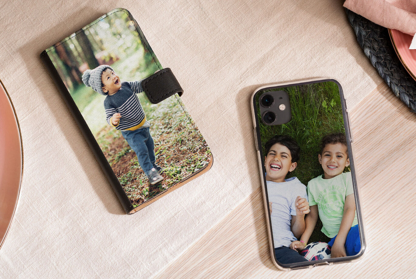 Two mobile phones with individual photos on a wooden surface.
