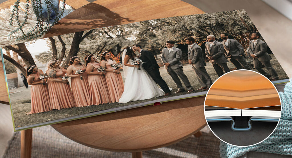 Beautiful wedding photo book with the bride and groom and bridesmaids on a table.