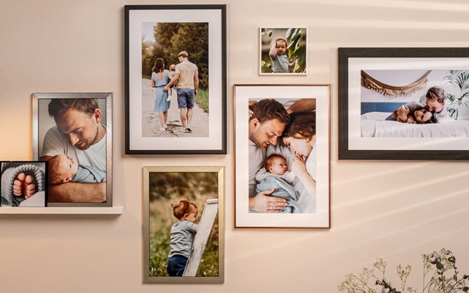 Family photos showing moments of happiness and love, framed beautifully on a wall.
