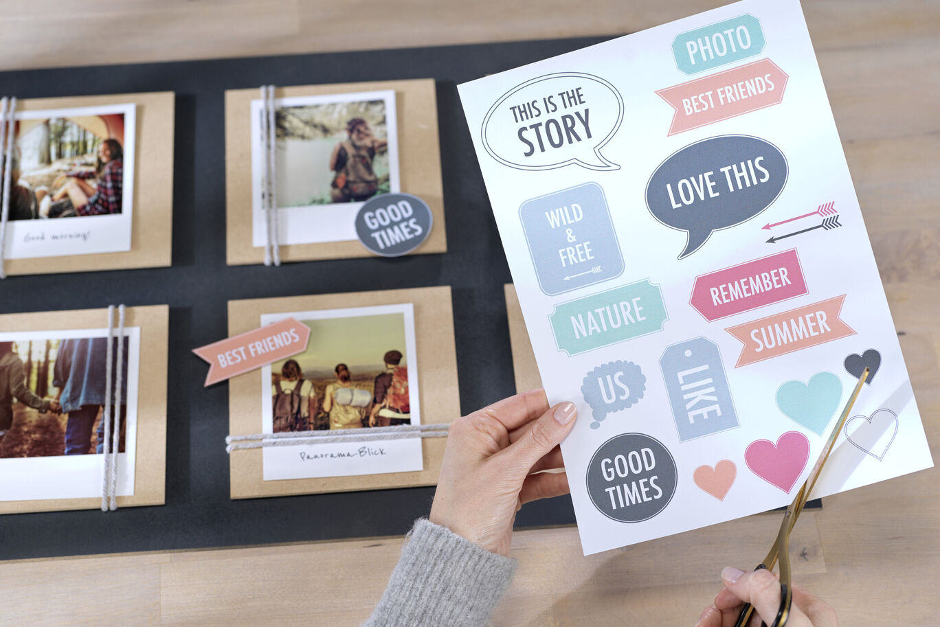 Supportive hand with scissors cuts heart stickers for creative photo design