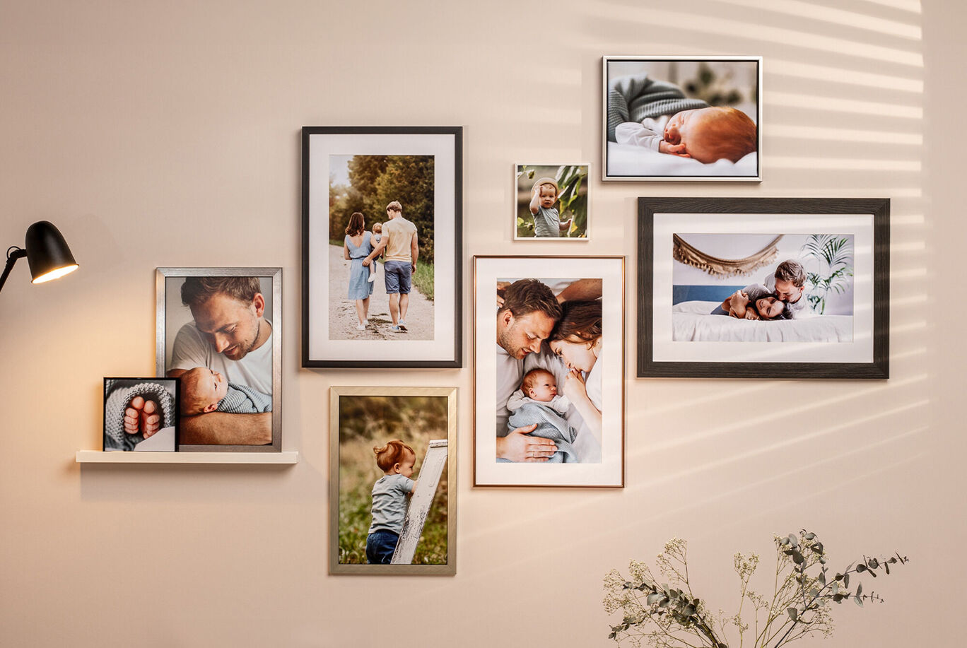 A lovingly designed wall display with family photos in colorful frames.