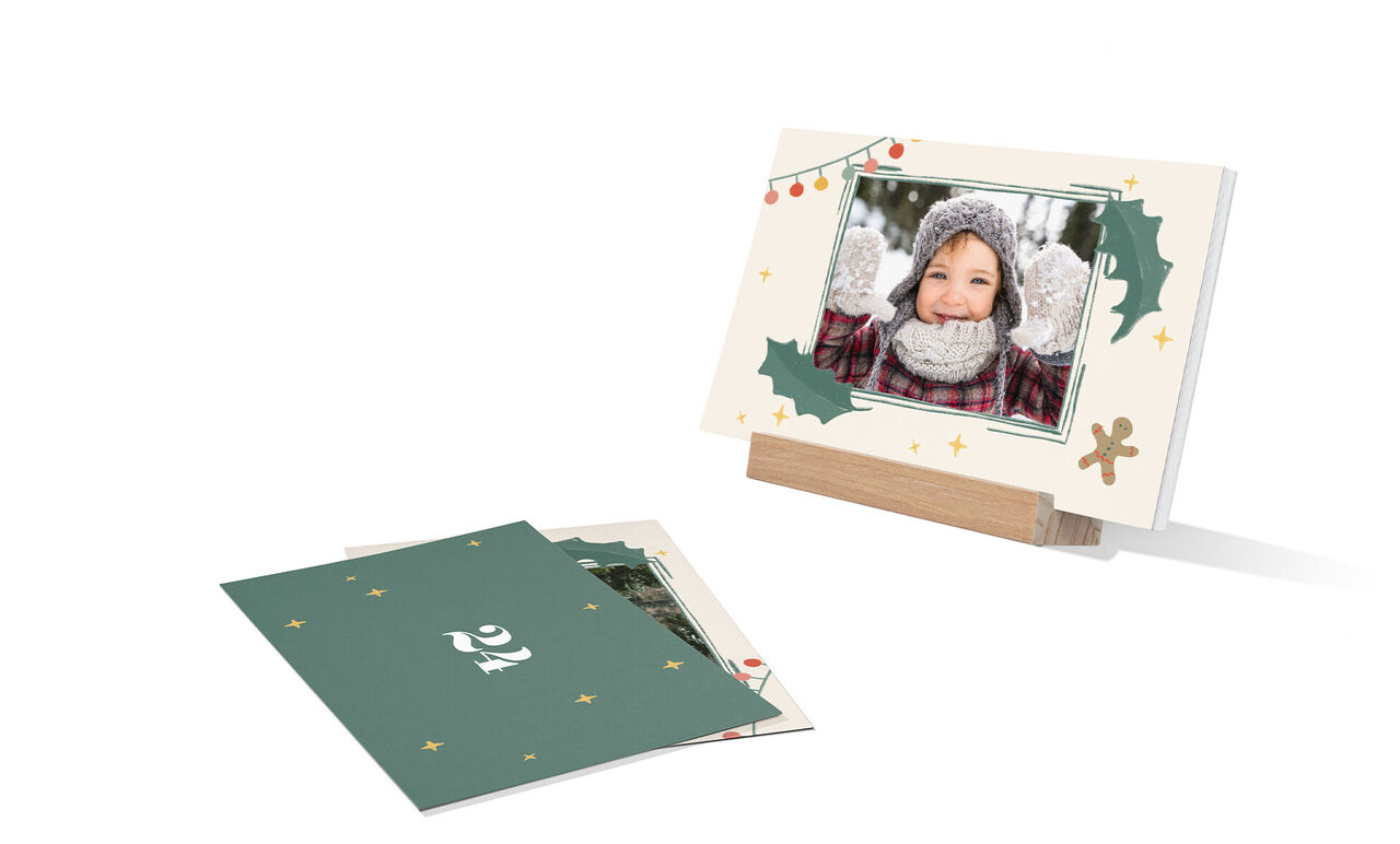 A festive greeting card on recycled paper. The background shows fir branches and Christmas stars. Drawing in the foreground.