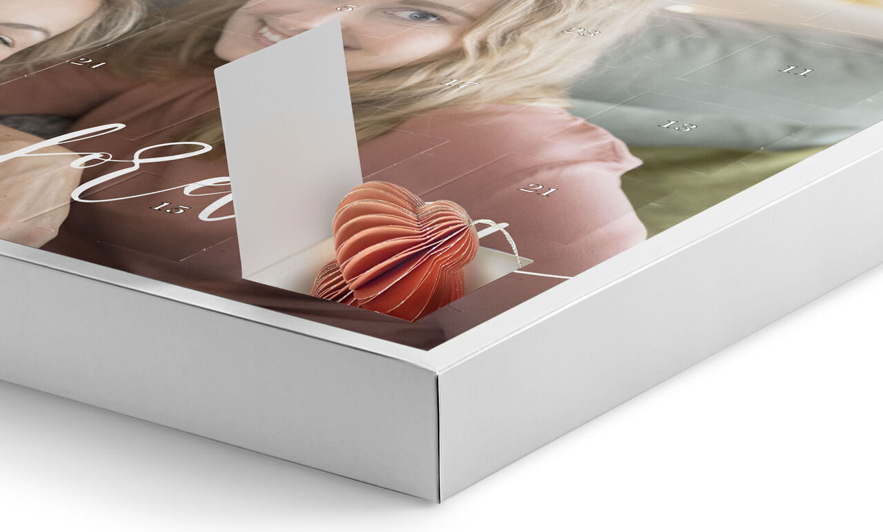 Close-up of a CEWE photo calendar showing a heart-shaped pop-up card sticking out.