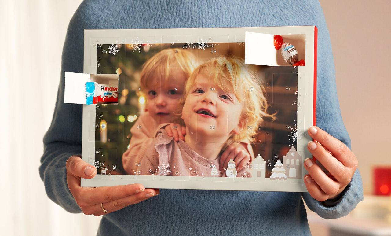 A person holds a festive frame with a nice photo and decorative elements, ideal for personal memories.