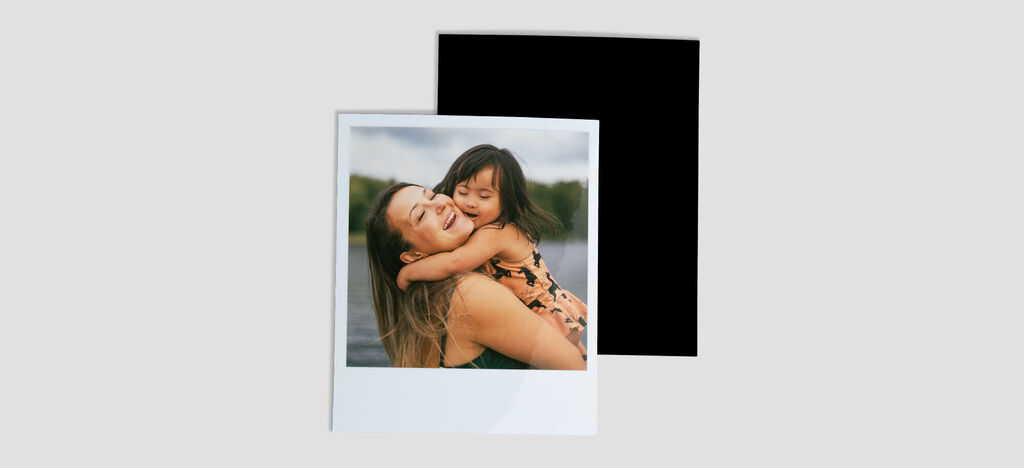 A loving hug between a mother and her child by the water.